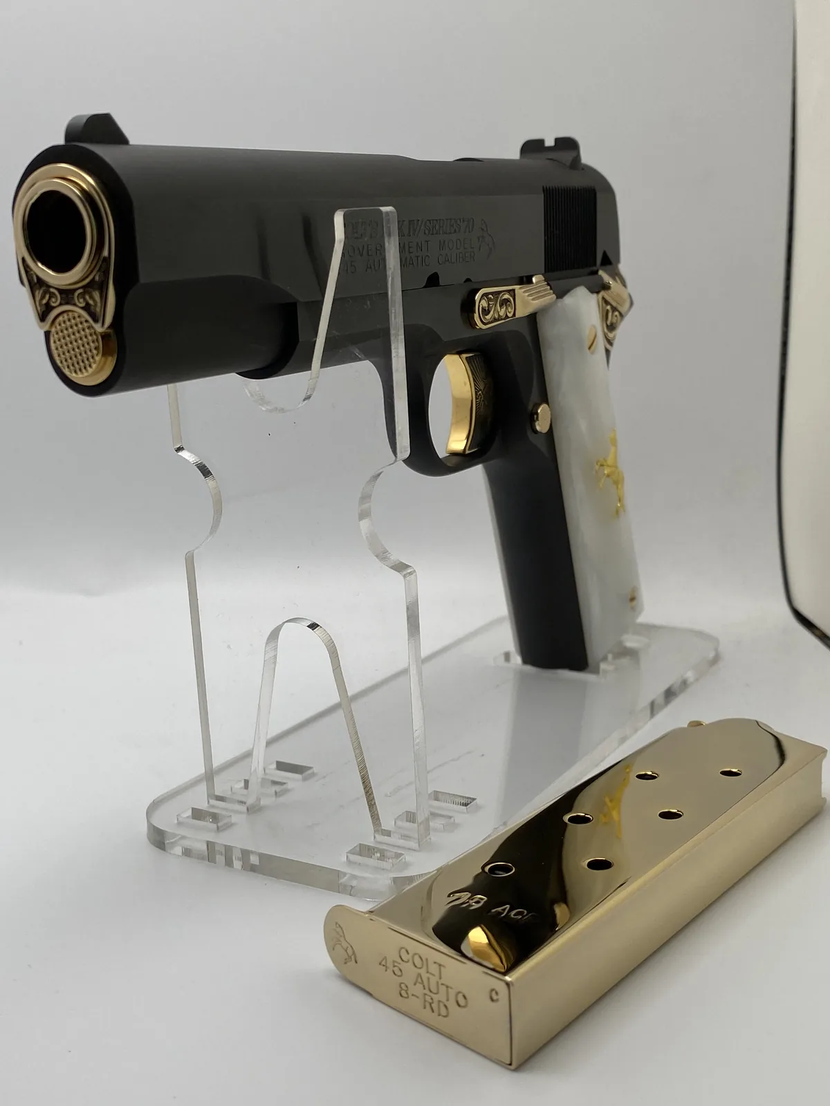 1911 in black with gold accents and pearl grips
