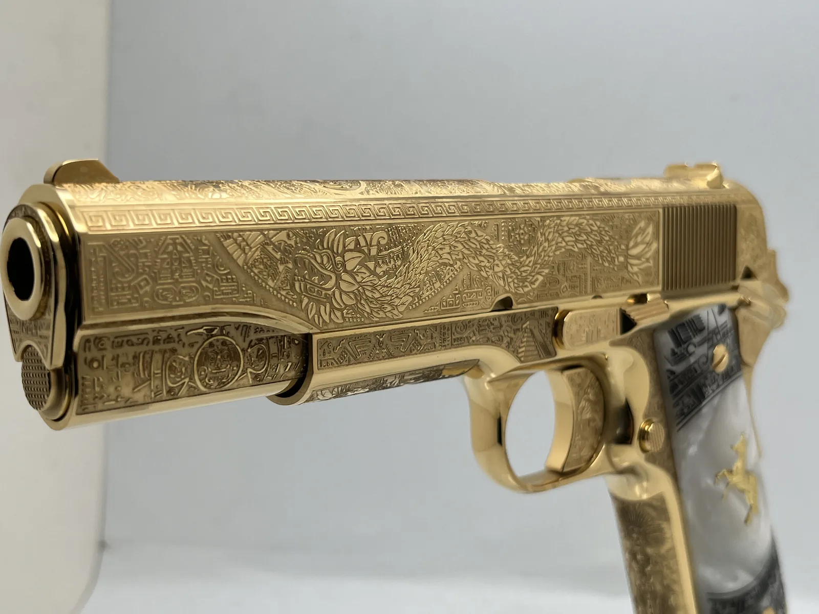 1911 with Aztec feathered serpent engraving and pearl grips