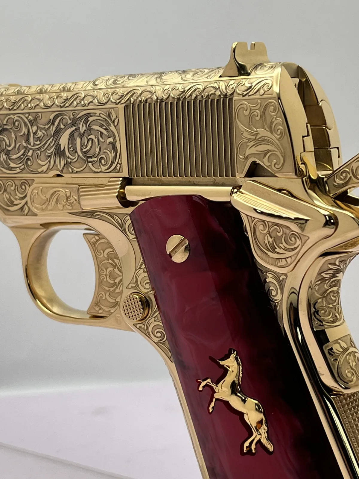 1911 with deep relief scroll engraving and red pearl grips