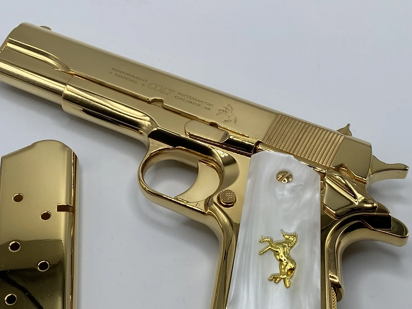 1911 with pearl grips and gold horse inlay