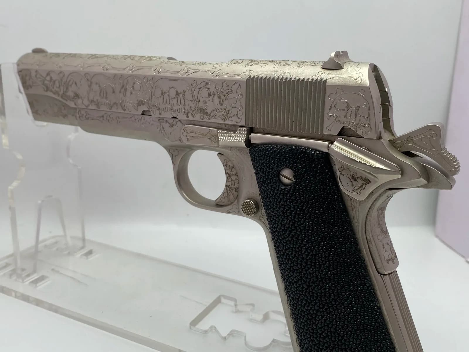 1911 with skull and crossbones engraving and stingray grips