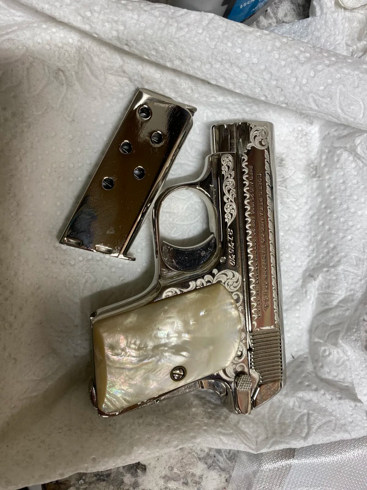 Colt pocket pistol with scroll engraving and pearl grips