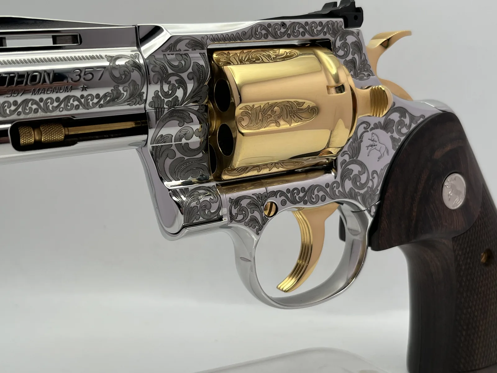 Colt Python with scroll engraving and gold cylinder