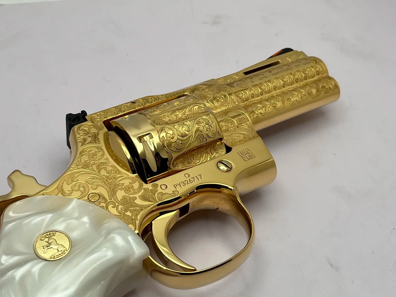 Colt revolver with scroll engraving and pearl grips