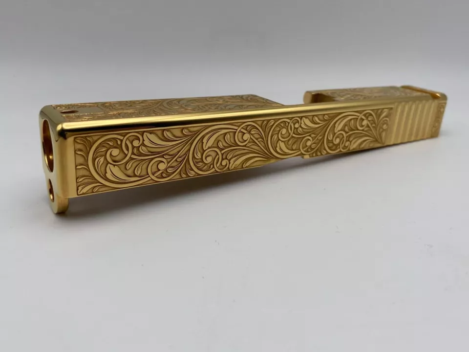 Glock slide with deep laser engraved scrollwork