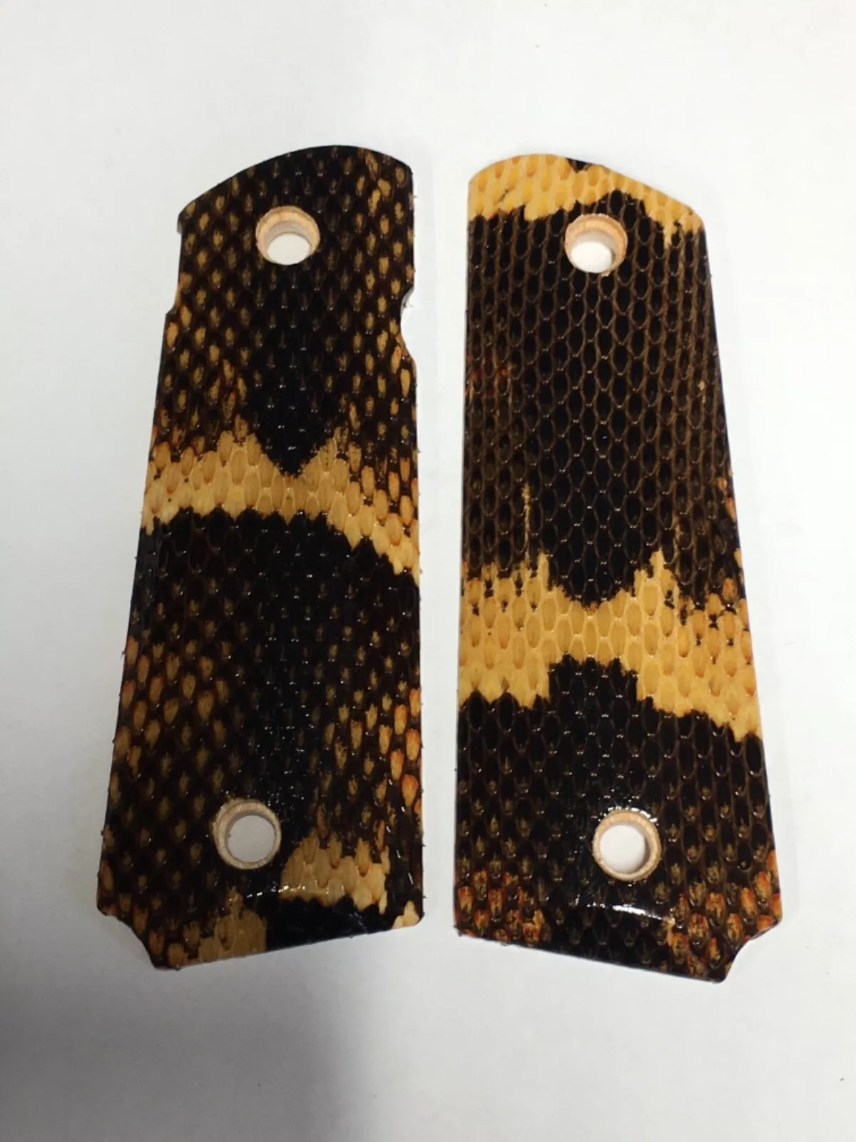 Full-size ambi-cut 1911 pistol grips wrapped in broad banded water snakeskin